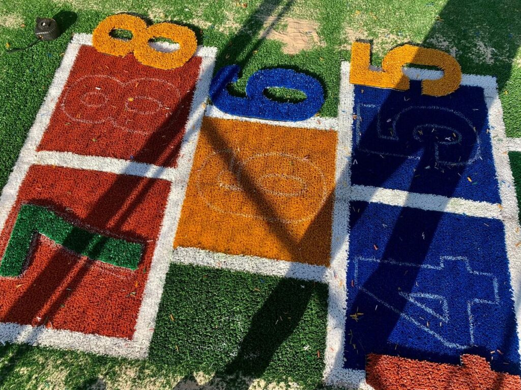 Coloured playground turf with a hopscotch layout